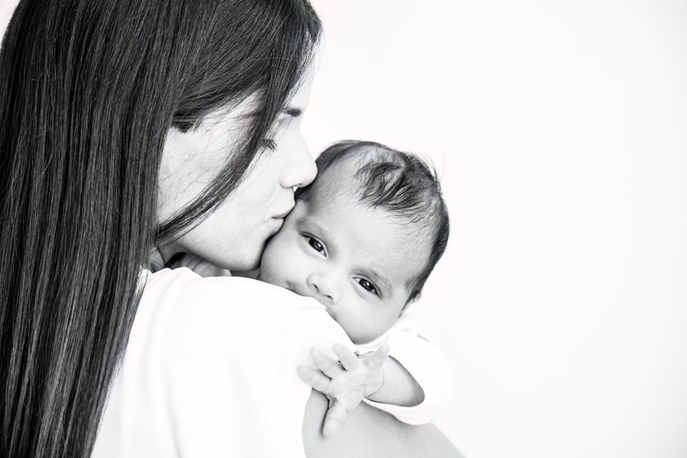 beautiful photography of an older newborn baby in mummy's arms at a bexley baby photoshoot in Kent